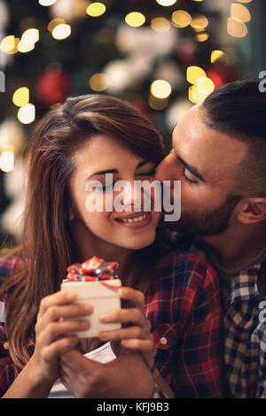 Junge Frau und Mann in Liebe Küsse auf Heiligabend Stockfoto