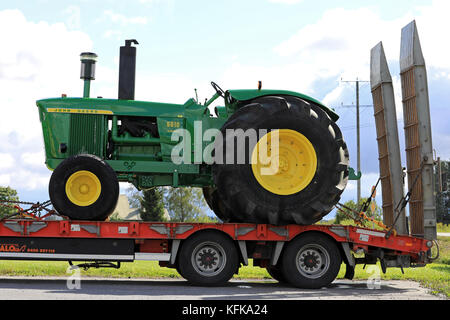 Koski tl, Finnland - 1 September, 2017: Klassische John Deere 5010 Traktor auf Fahrzeug Anhänger im Süden Finnlands transportiert. Die 5010 hergestellt wurde ich Stockfoto