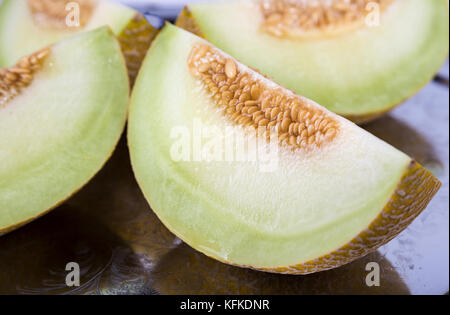 Frische gelb cantaloupe Cut in Viertel auf dem alten Fach im Detail Stockfoto