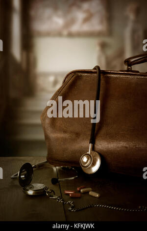 Vintage ärzte Tasche mit Stethoskop, Taschenuhr und Pillen Stockfoto