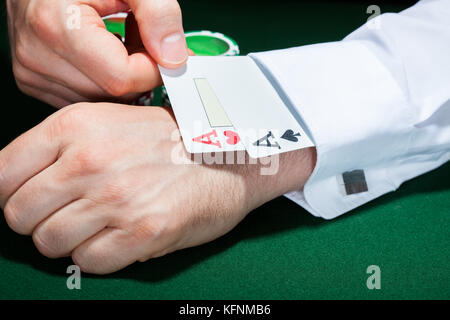 Nahaufnahme von Menschenhand mit Spielkarten in Hülse Stockfoto