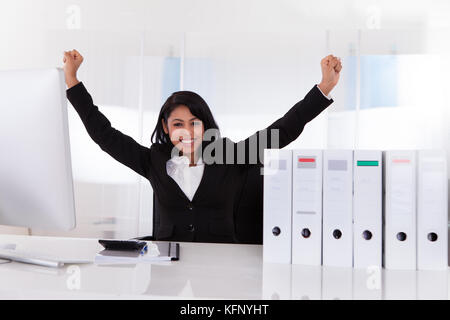 Portrait von Happy Geschäftsfrau mit der Hand angehoben Stockfoto