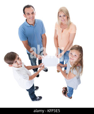 Erhöhten Blick auf Familie mit zwei Kindern halten leeres Papier, Isolated On White Background Stockfoto