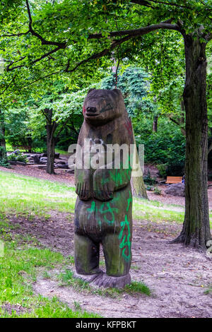 Berliner Volkspark Priedrichshain, öffentlicher Park. Bärenskulptur aus Holz, öffentliche Kunst, Berliner Emblem Stockfoto