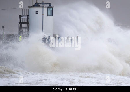 Wellen gegen die Hafenmauer während Sturm Brian bei Porthcawl, South Wales. Das Met Office haben einen gelben Wetter Warnung für Wind- und ha ausgestellt Stockfoto