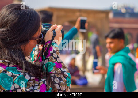 Delhi, Indien - 27. September 2017: Nahaufnahme einer Frau, die Fotos von der Veranstaltung der indischen Leute ihre Gesichter im Innenhof der Jama Masjid Moschee in Delhi, Indien cleanning Stockfoto