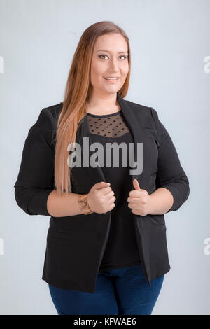 Porträt einer wunderschönen übergewichtige junge Frau in legere Kleidung stehen, Studio. Stockfoto