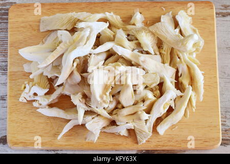 Cut Austernpilze auf einer hölzernen Schneidebrett. Schritt für Schritt kochen Stockfoto