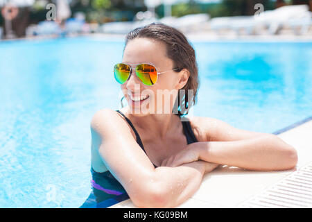 Schöne junge Frau im Pool Stockfoto