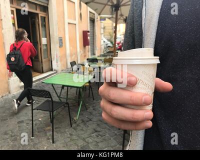 Rom, Italien. November 2017. ILLUSTRATION - Ein Mann hält einen Kaffee zum Mitnehmen in einer Kaffeetasse in Rom, Italien, 2. November 2017. Quelle: Lena Klimkeit/dpa/Alamy Live News Stockfoto