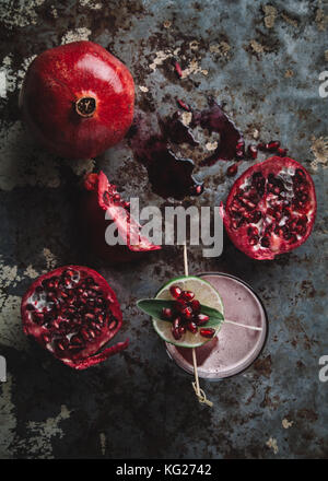 Alkoholfreien cocktail garniert mit Granatapfel Samen auf dunklen Moody Hintergrund Stockfoto