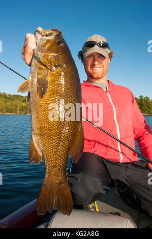 Lächelnde Menschen greifen smallmouth Bass Stockfoto