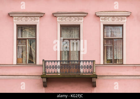 Drei Fenster in einer Reihe und Balkon auf der Fassade der städtischen Gebäude Vorderansicht, St. Petersburg, Russland Stockfoto