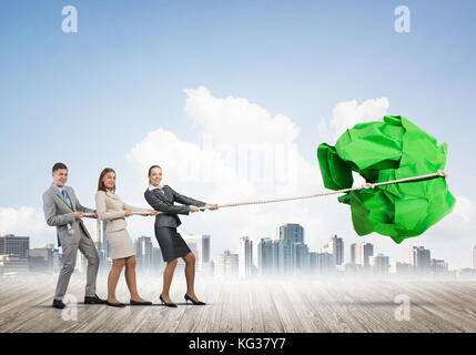 Junge Geschäftsleute im Freien und riesige Papier Kugel als Symbol der Kreativität Stockfoto