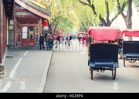 Touristen reiten Peking traditionelle Rikscha im alten China Hutong in Peking, China. Stockfoto