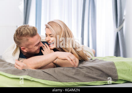 Gerne gemütlich Paar genießen eine gute Zeit im Bett in einer Decke abgedeckt Stockfoto