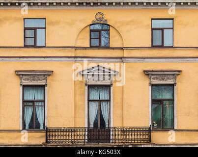 Mehrere Fenster in einer Reihe und Balkon auf der Fassade der städtischen Gebäude Vorderansicht, St. Petersburg, Russland Stockfoto