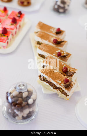 Süße Desserts, Kuchen mit Beeren und Früchte auf den Tisch serviert. wunderschön angelegten Kuchen auf der Untertasse Draufsicht, Soft Focus. Stockfoto