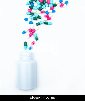 Gießen Antibiotika Kapsel Pillen in die Plastikflasche auf weißem Hintergrund mit Kopie Raum isoliert. Droge Storage, Antibiotikum Drogenkonsum mit angemessenen, Stockfoto