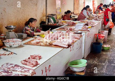Lijiang, Yunnan, China - September 27, 2017: Frauen verkaufen frisches Fleisch auf dem lokalen Markt. Stockfoto