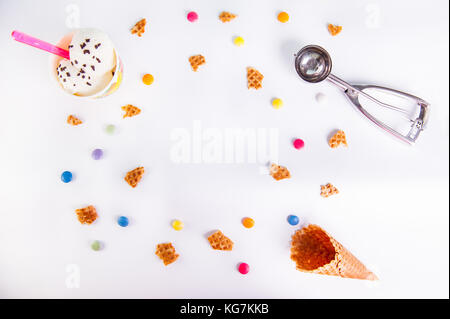 Weißer Hintergrund mit bunten Bonbons, Waffeln, Eis und leeren Eis. Platz für Beschriftungen. top Aussicht, flach. selektive Schwerpunkte Stockfoto
