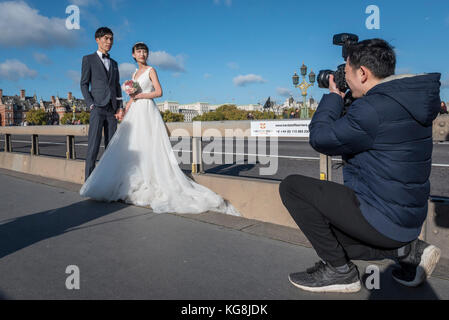 London, Großbritannien. 5. November 2017. Ein Chinesischer Paar hat vor - Hochzeit Fotographien auf die Westminster Bridge. Mit dem Rückgang von Sterling, London ist als immer günstiger Lage für solche Fotos gesehen, sowie die Sehenswürdigkeiten als Kulisse. Häufig, der Fotograf und Team sind auch aus China geflogen, um die Bilder zu erfassen. Credit: Stephen Chung/Alamy leben Nachrichten Stockfoto