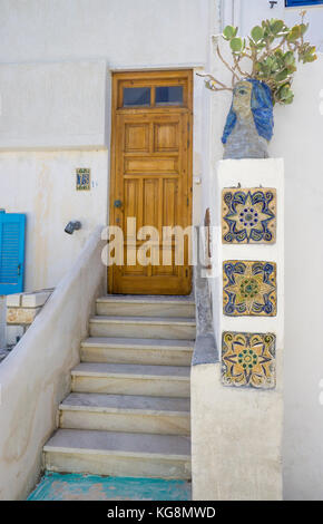 Hölzerne Tür und keramische Fliesen zu einem houese, kleine Fischerdorf Apollonas, Nordseite der Insel Naxos, Kykladen, Ägäis, Griechenland Stockfoto