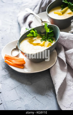 Hausgemachtes Bier Käse Suppe in grau Porzellanschale auf rustikalen konkreten Hintergrund Stockfoto