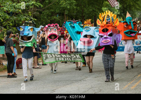 Atlanta, GA, USA - 29. April 2017: Menschen gehen in der Inman Park Festival Parade in Atlanta, tragen kreative übergroße Masken auf ihren Köpfen. Stockfoto