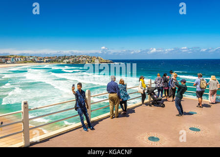 Touristen bewundern Sie den berühmten Bondi Beach vom Aussichtspunkt am südlichen Ende auf einem herrlichen sonnigen Tag. Sydney, New South Wales, Australien Stockfoto