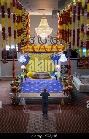 Eine einzelne Anbeter in der Baba Makhan Shah Lobana Sikh Center auf 101 Avenue in Richmone Hill, Queens, New York City Stockfoto