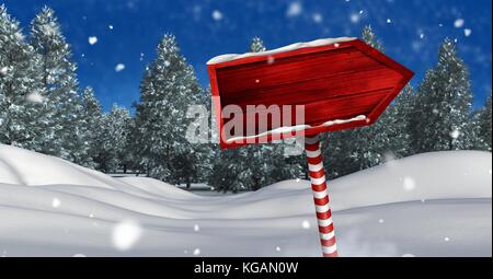 Digital composite der hölzernen Wegweiser in Weihnachten Winter Landschaft Stockfoto
