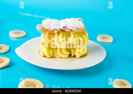 Bananen Kuchen in einer Platte auf blauem Hintergrund Stockfoto