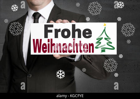 Frohe Weihnachten (Frohe Weihnachten) Repräsentant wird durch Unternehmer statt. Stockfoto