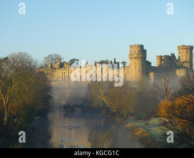 Sonnenaufgang am Schloss Warwick mit Morgennebel über dem Fluss Avon driften Stockfoto