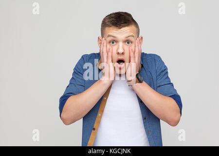 Angst Konzept. boy Holding Kopf ihre Hände geöffneten Mund und großen Augen haben. indoor Schuß Stockfoto