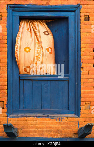 Wehende Vorhänge aufhängen aus einem blauen Fenster, Bandipur, Tanahun Bezirk, Nepal Stockfoto