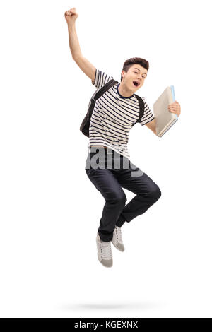 Überglücklich teenage Student springen und gestikulierend Glück auf weißem Hintergrund Stockfoto