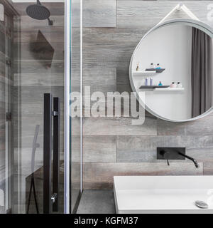 Badezimmer mit begehbarer Dusche, Arbeitsplatte Waschbecken und Fliesen Holzoptik Stockfoto