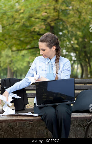 Business Frau mit zerknittertem Papier in seinen Händen, outdoor Stockfoto