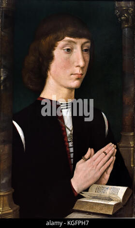 Ein junger Mann im Gebet Mitte 1470 Hans Memling 1430 - 1494 war ein deutscher Maler, die nach Flandern gezogen und in der Tradition des frühen niederländischen Malerei gearbeitet. Deutschland Stockfoto