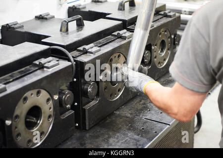 Innerhalb einer Fabrik, Industriearbeiter in Aktion auf Metall Maschine Stockfoto