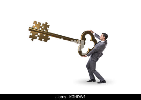Geschäftsmann mit Schlüssel und Puzzle Stücke Stockfoto