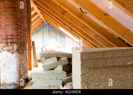 View of attic renovation and construction site with pile of rockwool prepared to be installed Stockfoto