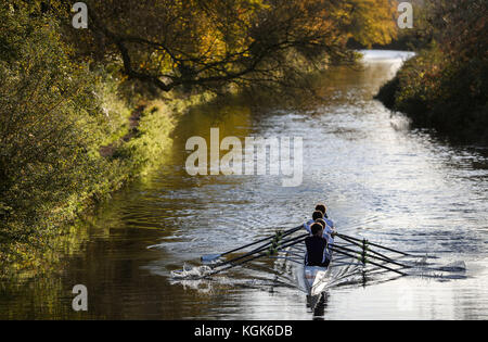 Ruderer vom Winchester College Ruder Club machen ihren Weg entlang der Itchen Navigation in Winchester. Stockfoto