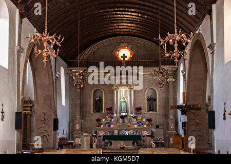 Innenraum der Kirche Templo de Nuestra Señora del Sagrario mit einer Holzfassdecke und kupferfarbenen Kronleuchtern in Santa Clara del Cobre, Michoacan, Mexiko. Stockfoto
