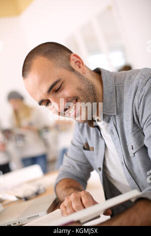Lächelnden jungen Mann lesen Buch Stockfoto