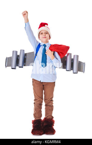 Junge Santa Claus mit einem Jetpack auf dem Rücken hält Geschenke für Weihnachten Stockfoto