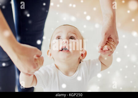 glückliches Baby mit Mutter Hilfe laufen lernen Stockfoto