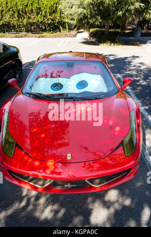 Roten Ferrari 458 Italia mit lustigen Augen, Lightning McQueen Cars Film merchandising Windschutzscheibe Sonnenschirmen. Im Silicon Valley, Kalifornien. Stockfoto